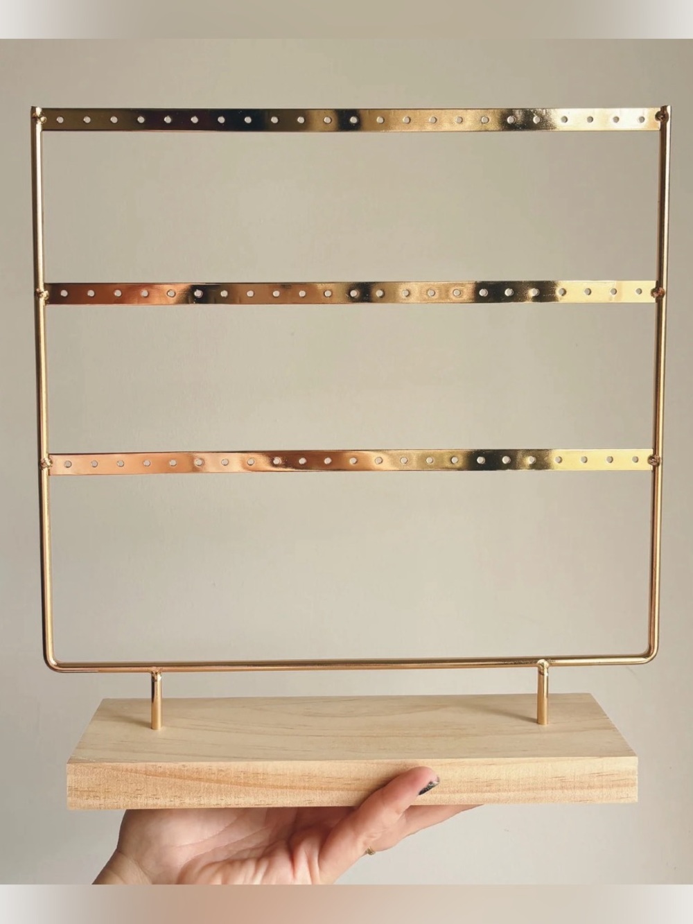 3-tier earring holder stand featuring a gold-toned metal frame w/ drilled holes